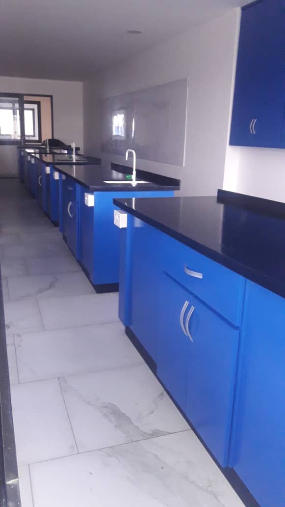 Cornerstone International School laboratory bench row with blue cabinets and black countertops